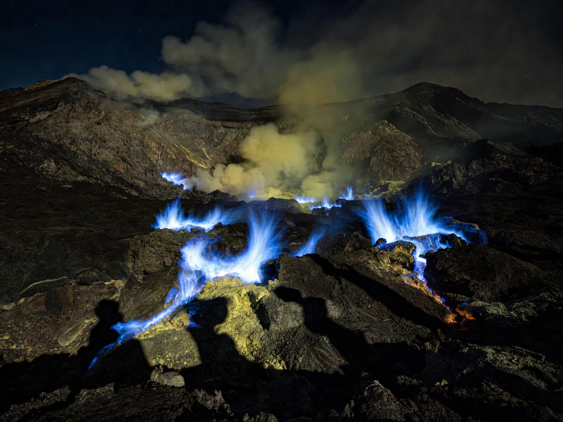 Superheated burning sulfur gas emitting glowing electric blue flames inside volcanic crater